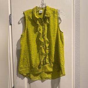 Sleeveless button front blouse with ruffle placket. Lined. 100% polyester.